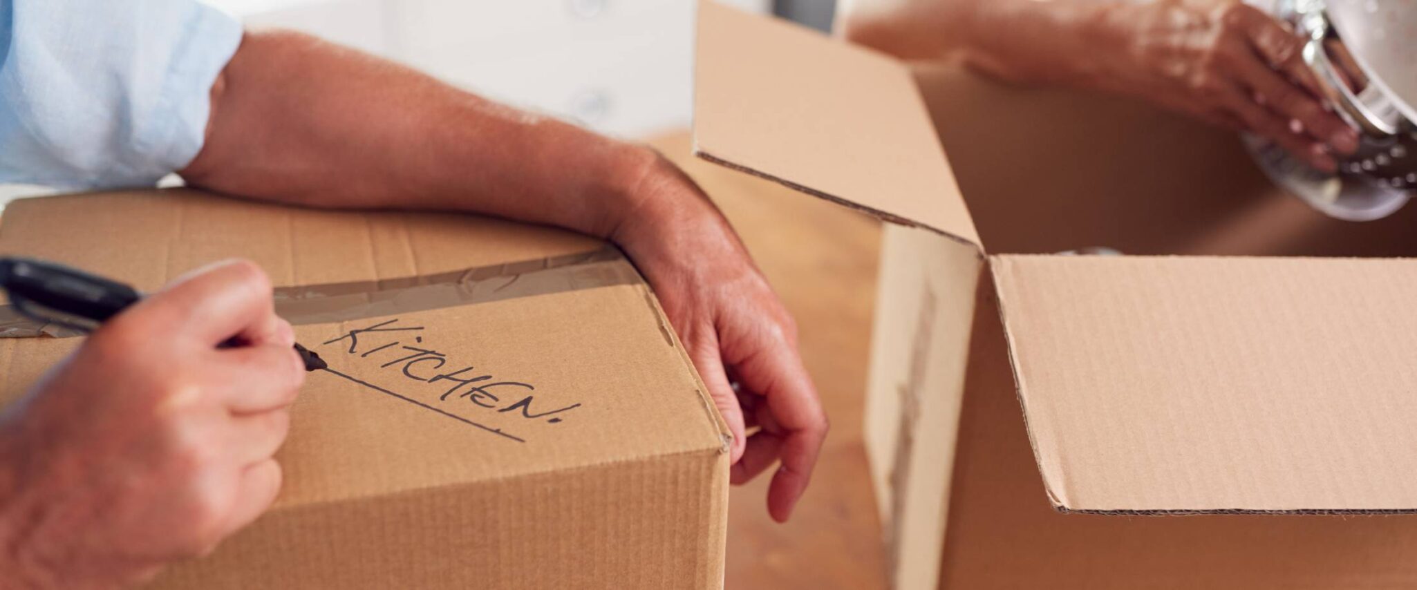 seniors packing up boxes to downsize into a senior living community