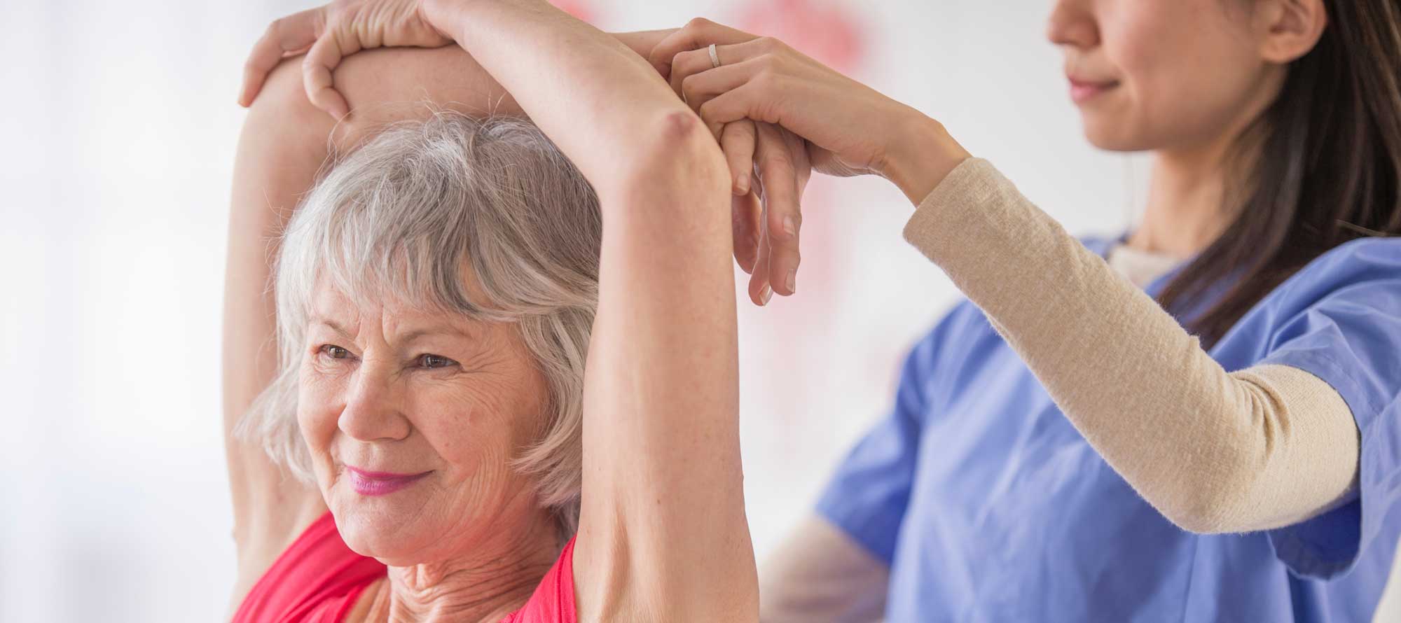 a skilled nursing caregiver helping a resident stretch
