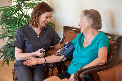 healthcare worker measuring a woman's blood pressure