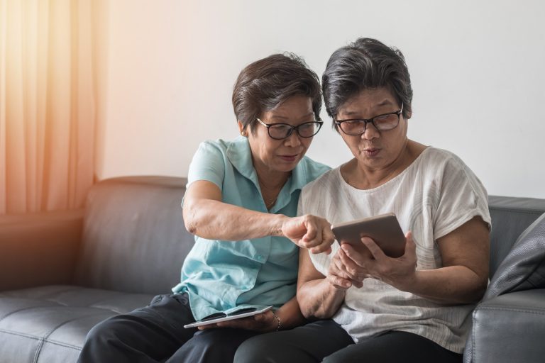 seniors looking at a tablet together