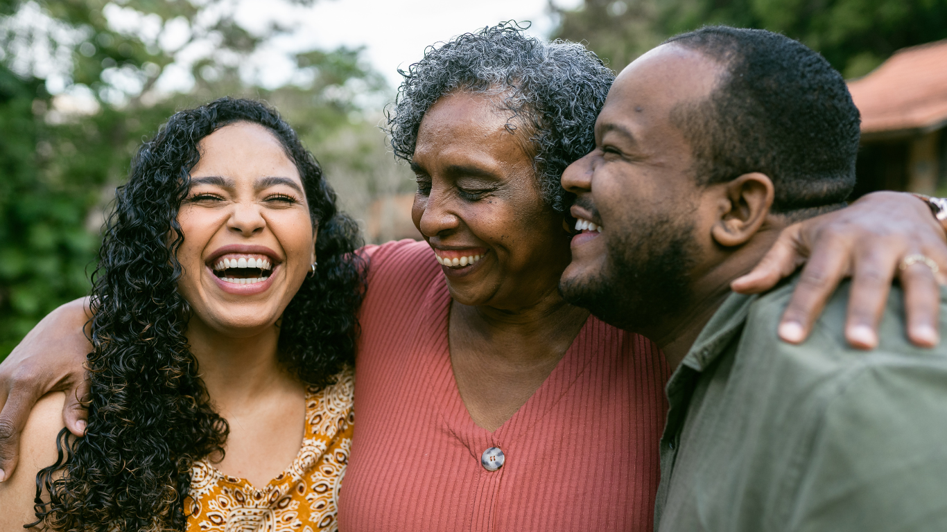 Senior mother hugging adult children