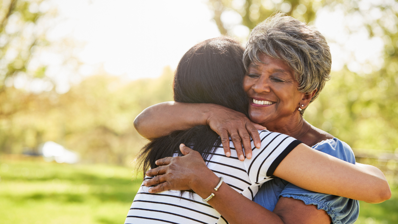 Senior mother giving her adult daughter a hug