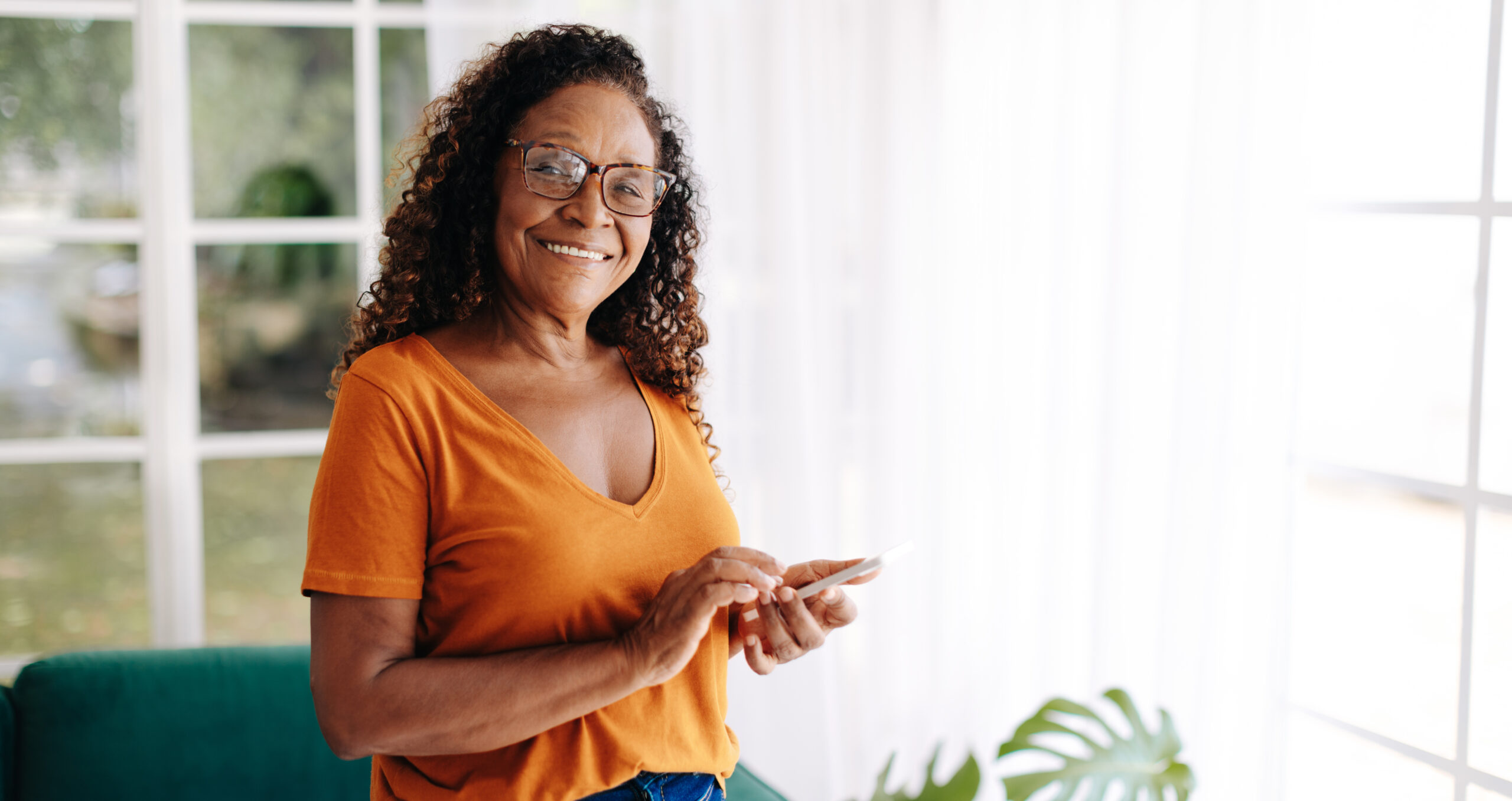 Senior woman at home looking at her smartphone