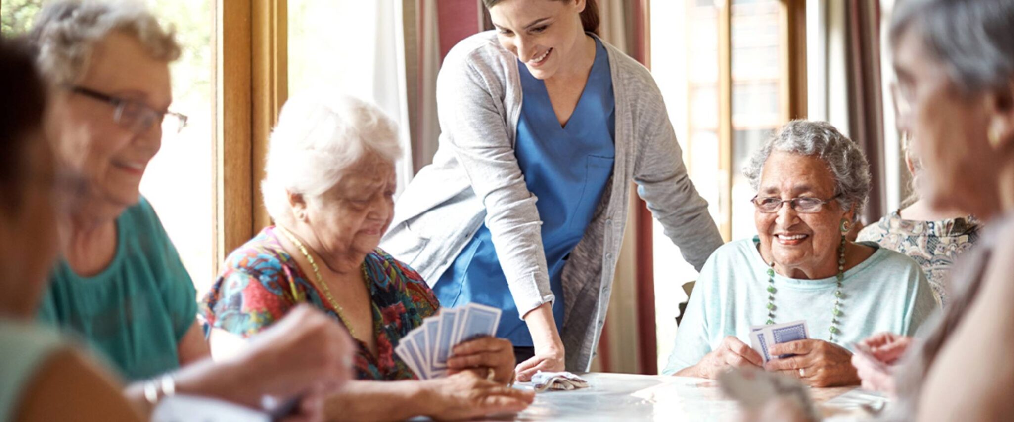 A group of seniors gather together to play card games