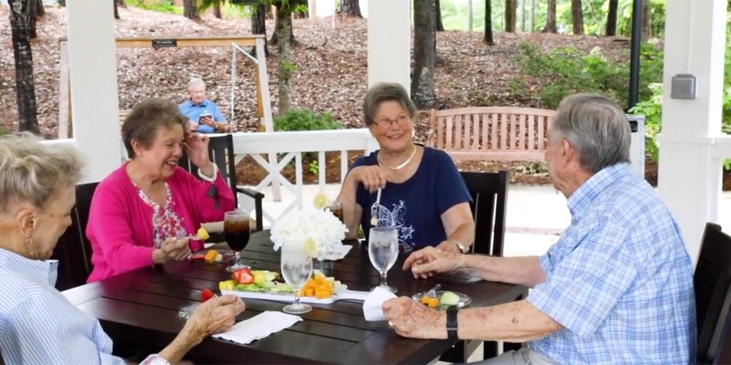 seniors at galleria woods enjoying cocktails on the patio