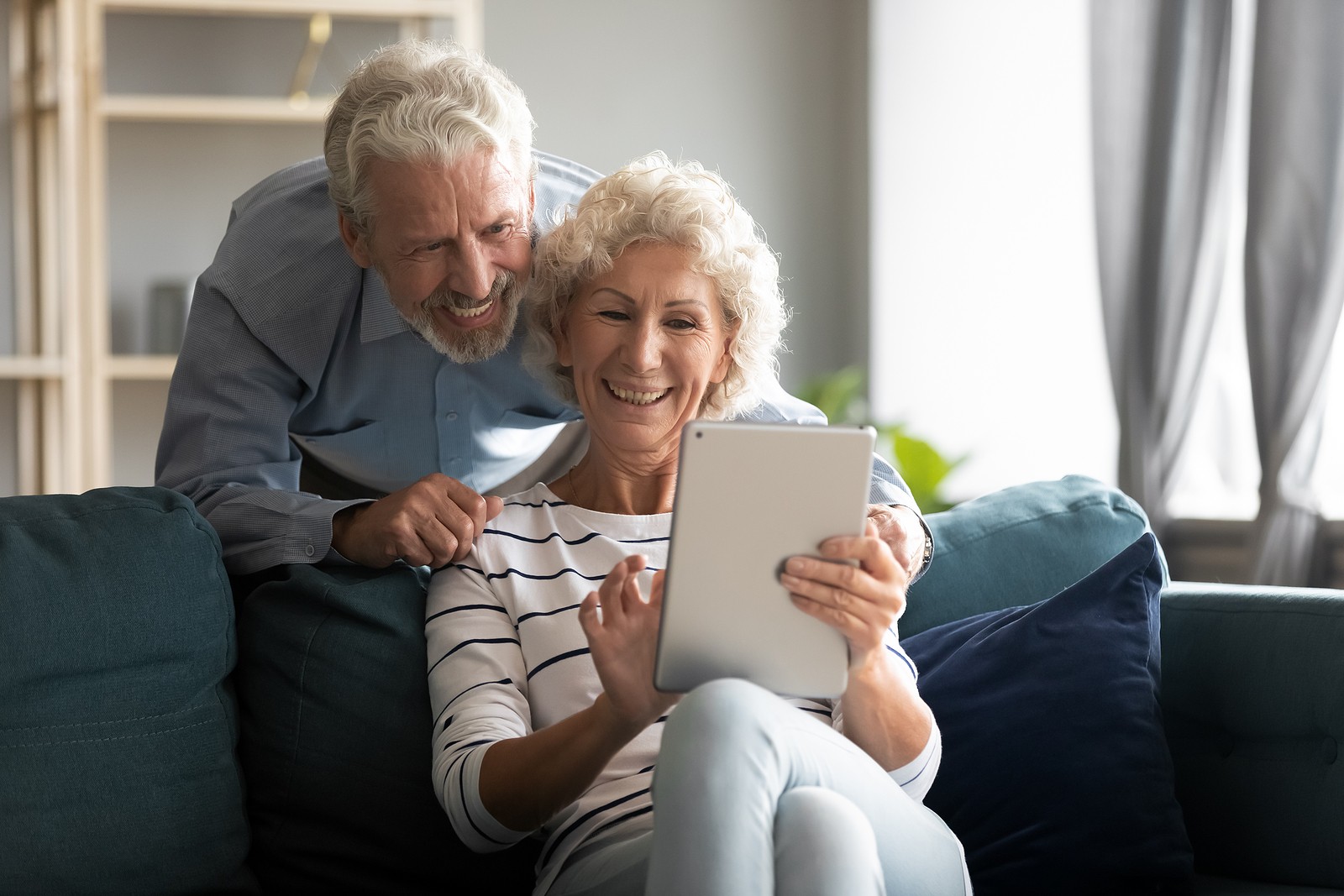 Young senior couple looking at something on a tablet together.