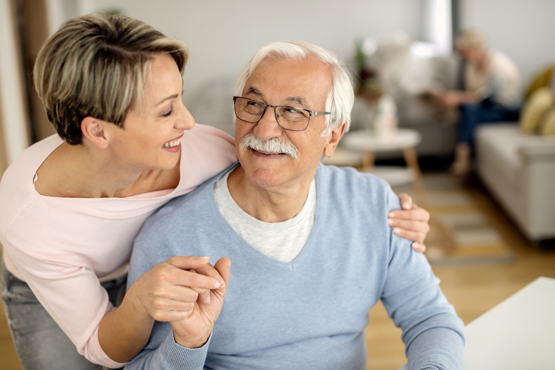 Happy senior man holding hands with his daughter