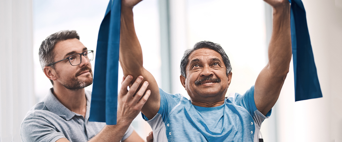 Man working on orthopedic physical therapy with male physical therapist