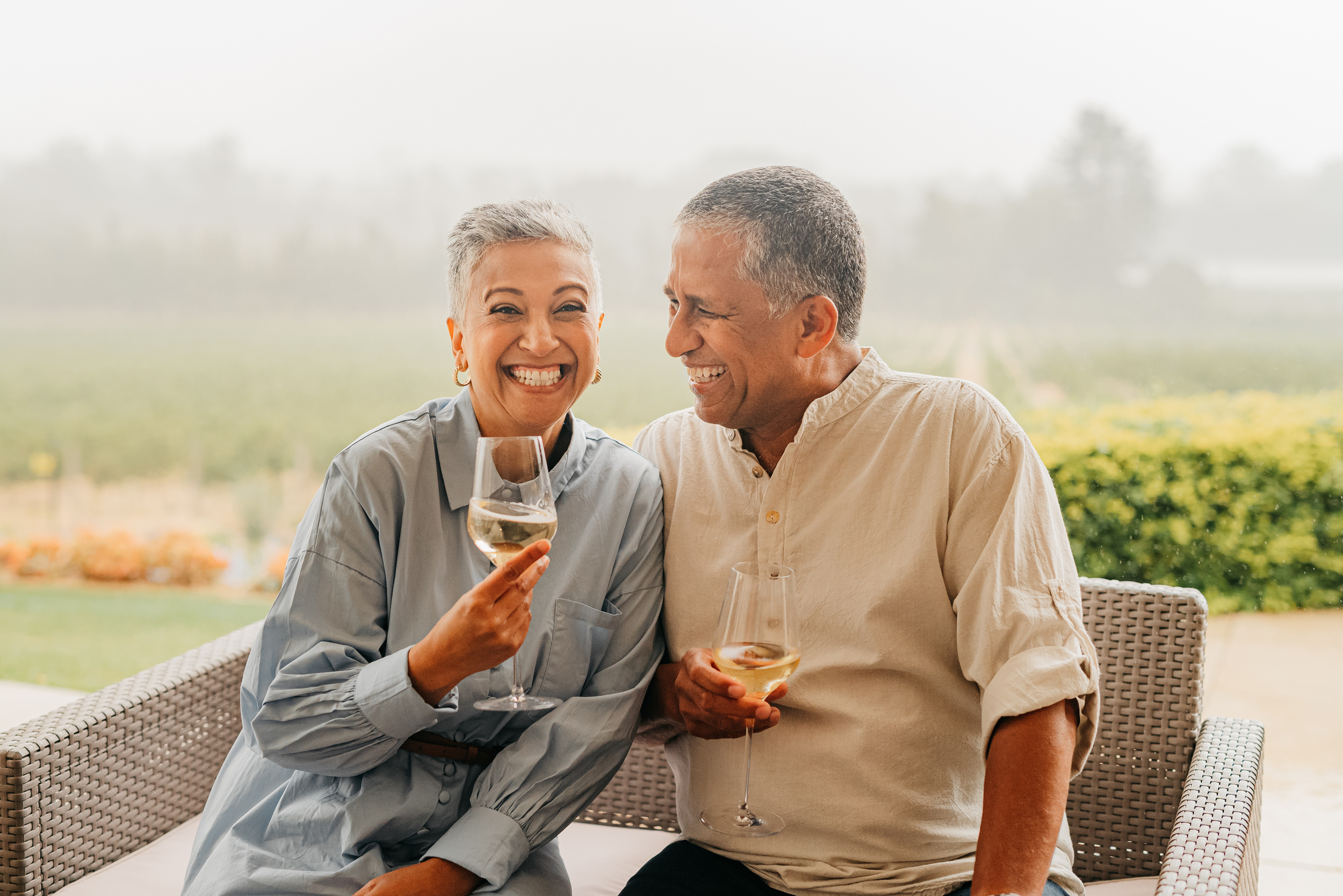 Senior couple at winery holding glasses of wine