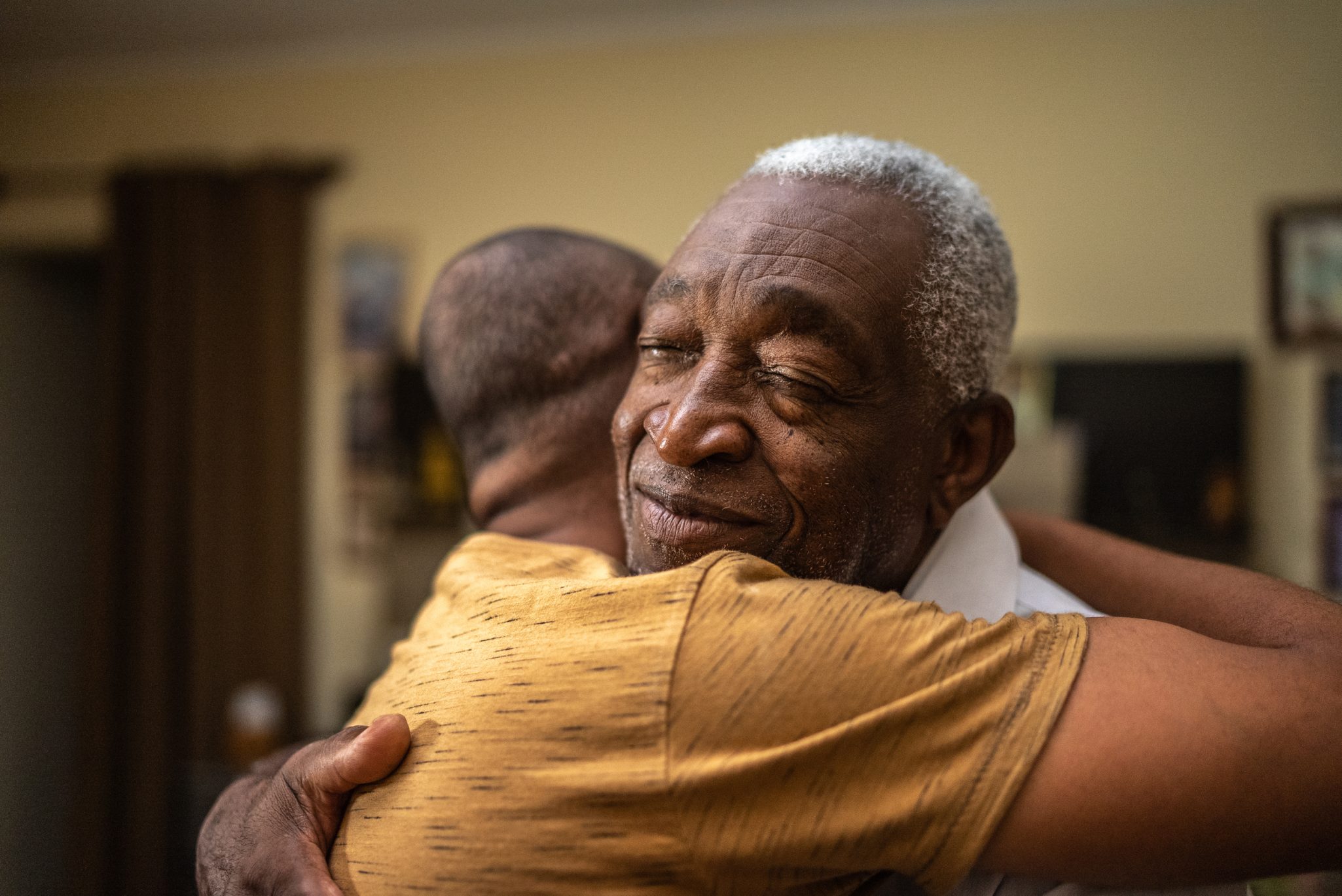 Father and son hugging one another
