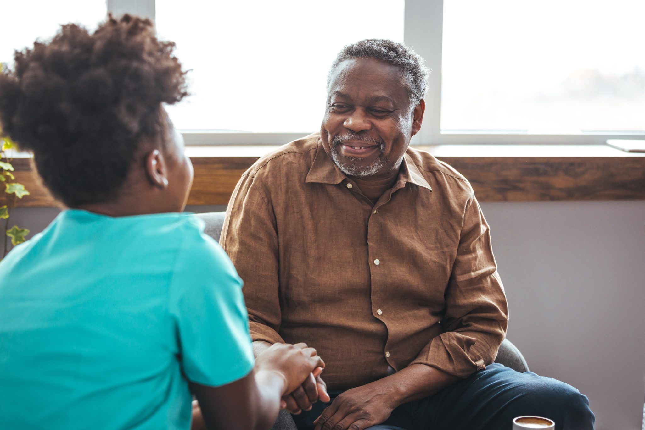 Senior man listening to female nurse