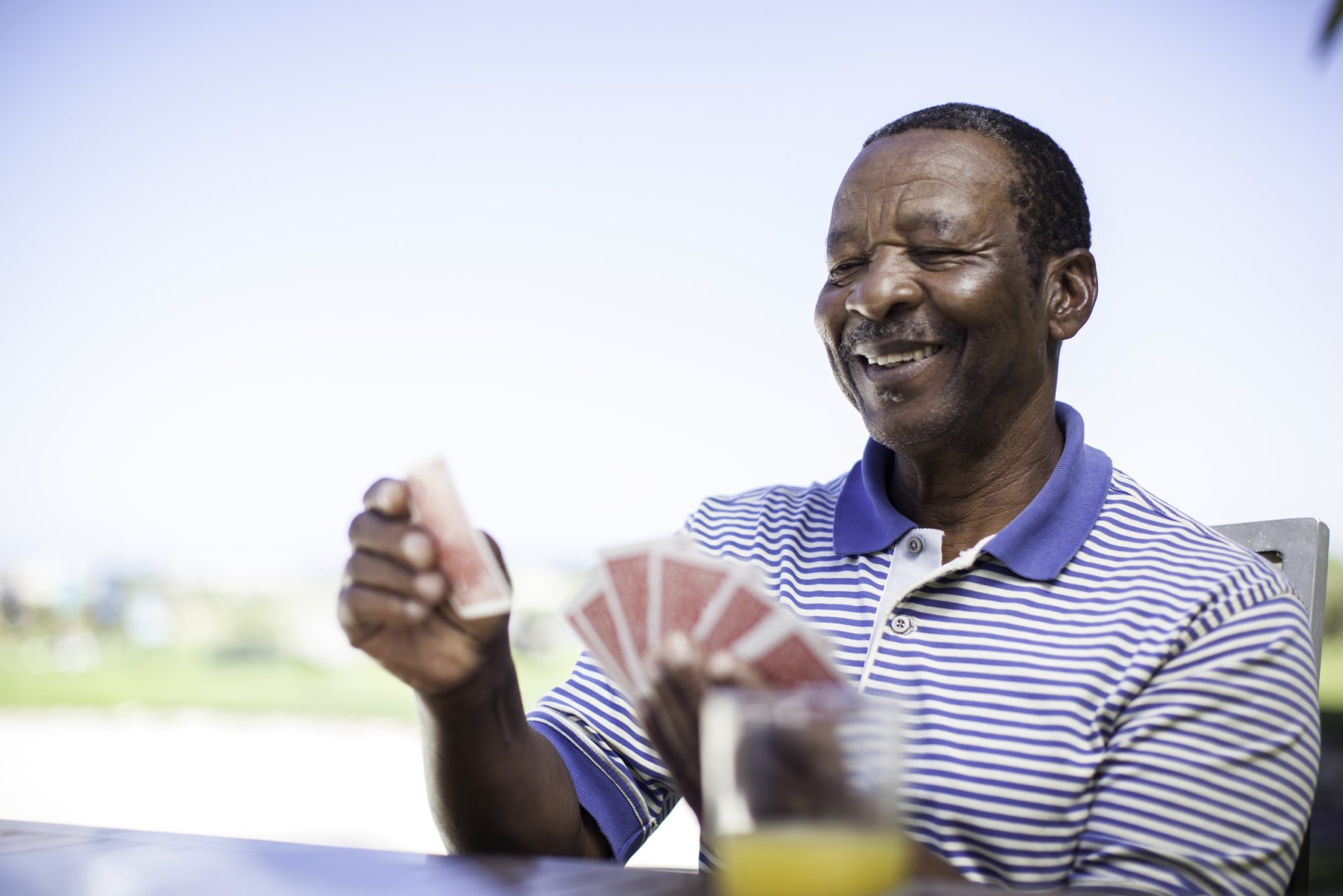 Senior man playing a game of cards